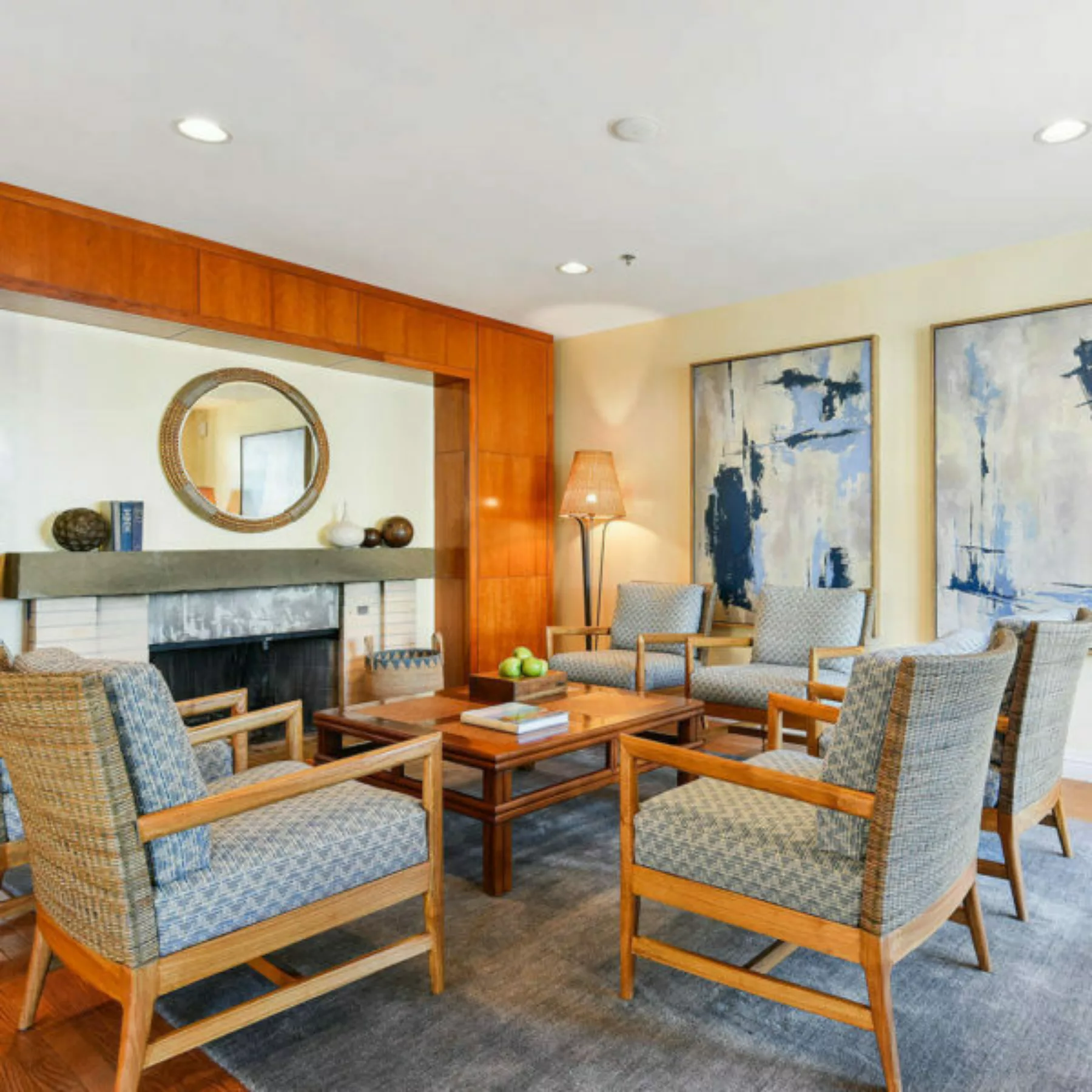 Six plush chairs in the lobby in front of the fireplace